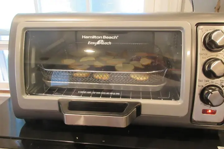 Countertop oven using an air fryer function illustrating the Kalorik MAXX safety warning