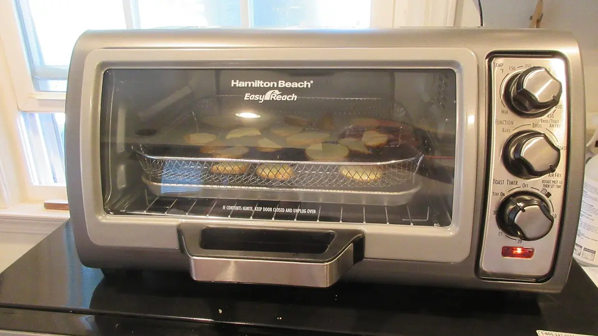 Countertop oven using an air fryer function illustrating the Kalorik MAXX safety warning