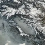 Satellite image showing the Kashmir Valley with mountain ranges and agricultural plains under clear weather conditions