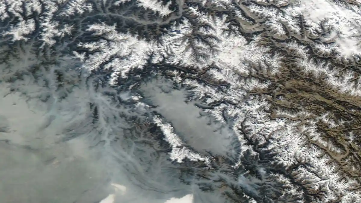 Satellite image showing the Kashmir Valley with mountain ranges and agricultural plains under clear weather conditions