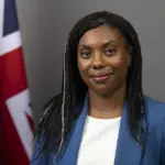 Kemi Badenoch in a formal portrait wearing a blue blazer