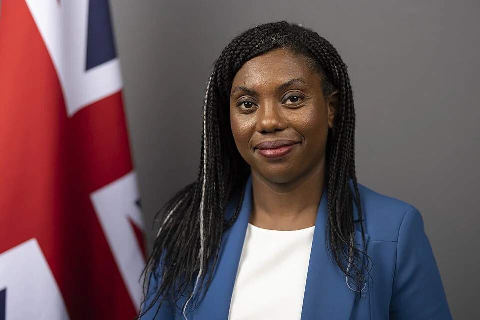 Kemi Badenoch in a formal portrait wearing a blue blazer
