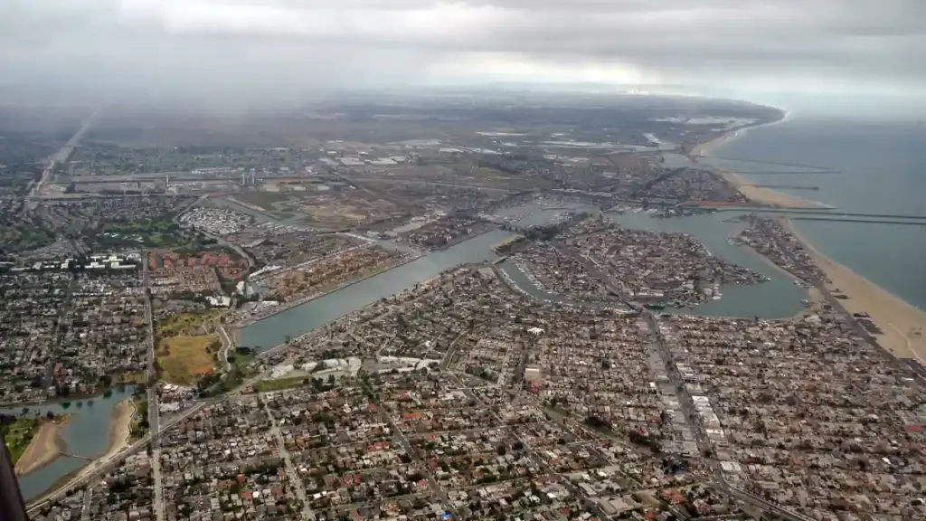 Coastal waterfront, seawall, and beachfront residences along Alamitos Bay in Long Beach, California.