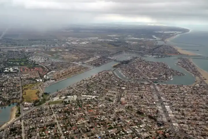 Coastal waterfront, seawall, and beachfront residences along Alamitos Bay in Long Beach, California.