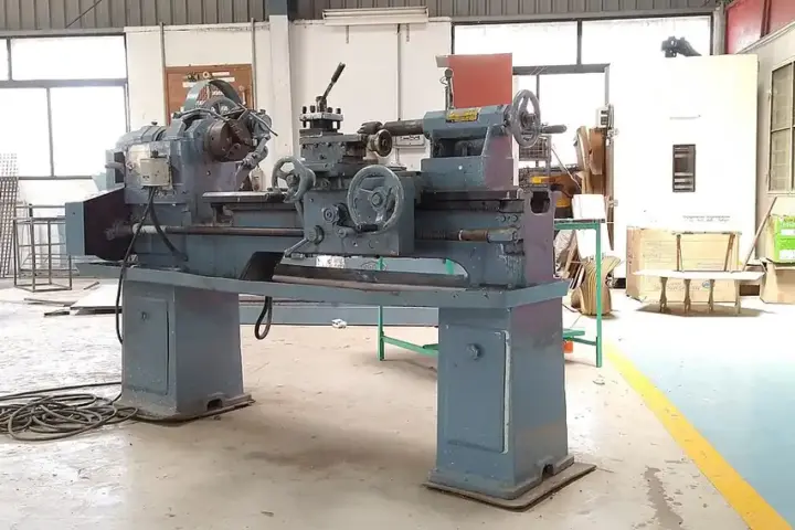 Clear view of an industrial precision metal lathe machine turning raw steel components inside an Indian manufacturing factory workshop.