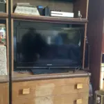 A flat-screen television mounted above a console table in a residential living room.