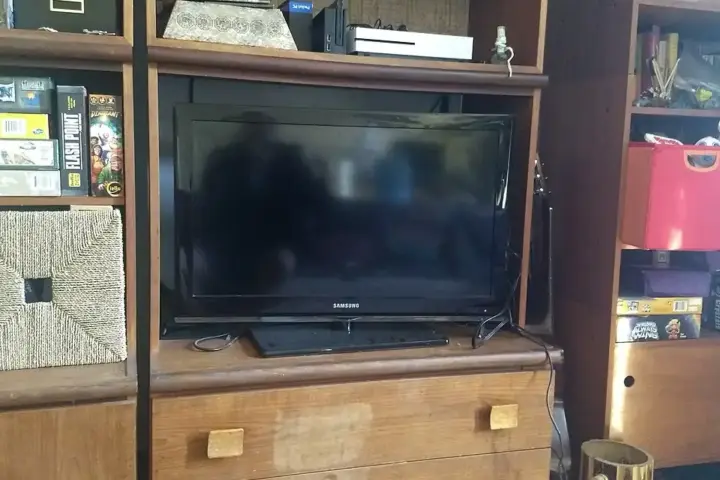 A flat-screen television mounted above a console table in a residential living room.