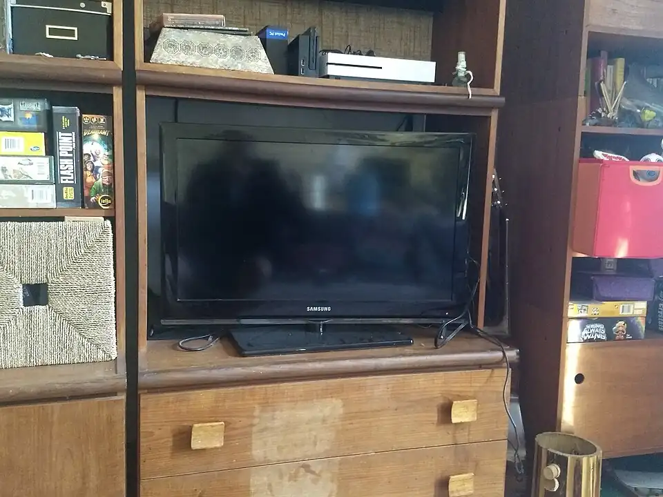A flat-screen television mounted above a console table in a residential living room.