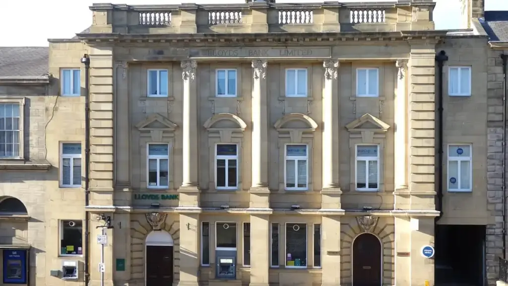 Exterior of a UK bank branch building with ATM machines and pedestrian entrance in a town centre