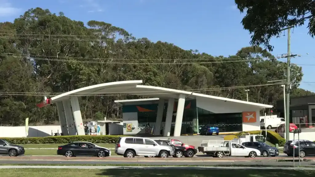 Australian service station forecourt with fuel dispensers, canopy structure and vehicle refuelling lanes