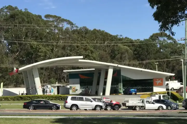 Australian service station forecourt with fuel dispensers, canopy structure and vehicle refuelling lanes