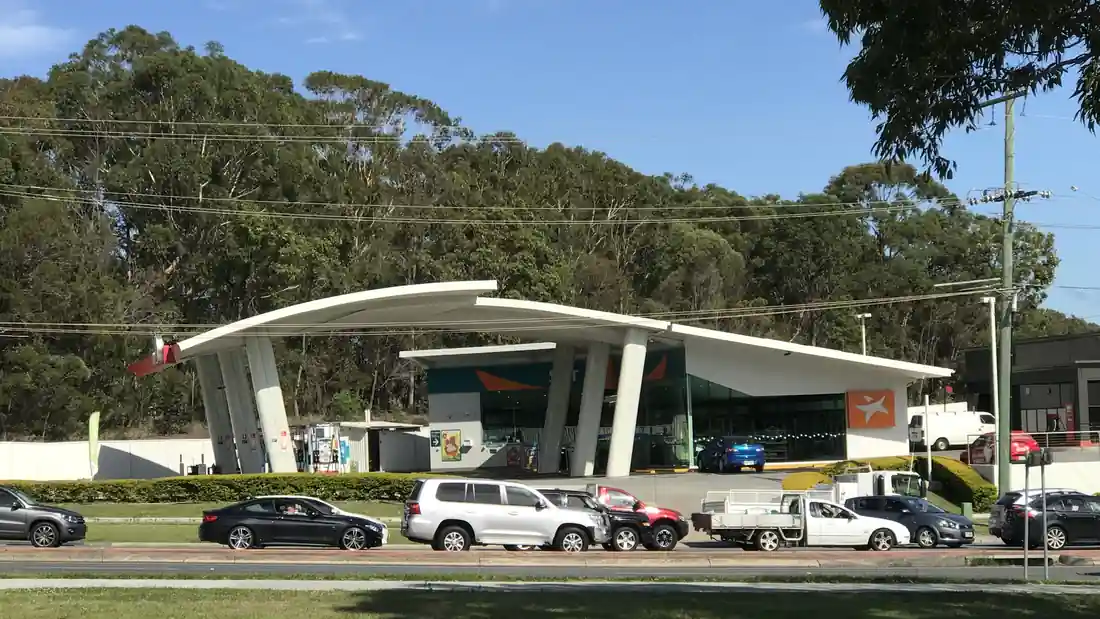 Australian service station forecourt with fuel dispensers, canopy structure and vehicle refuelling lanes