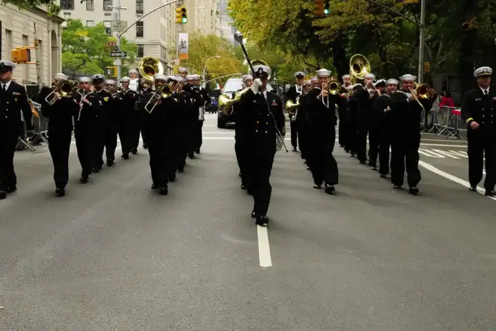 Formal parade procession with ceremonial marchers advancing along Fifth Avenue during the New York City Columbus Day Parade.