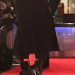 Television presenter Miranda Hart at a public event, speaking at a microphone in a professional setting