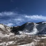 Heavy snow covering alpine mountain slopes and evergreen forests in Utah's La Sal Mountain range