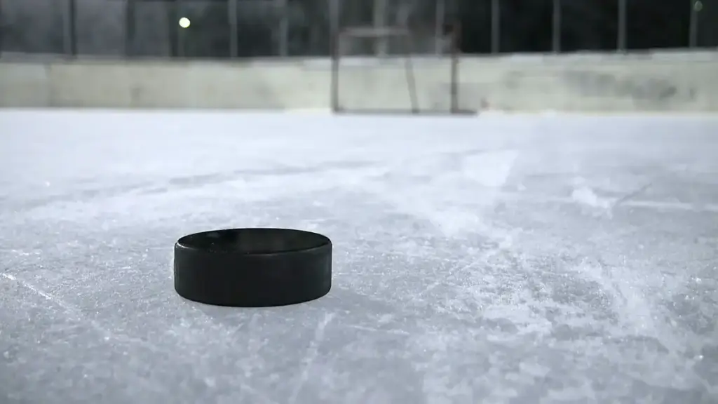 Black ice hockey puck resting on a clear outdoor ice rink, representing the hockey context of the Montreal Metros explainer.