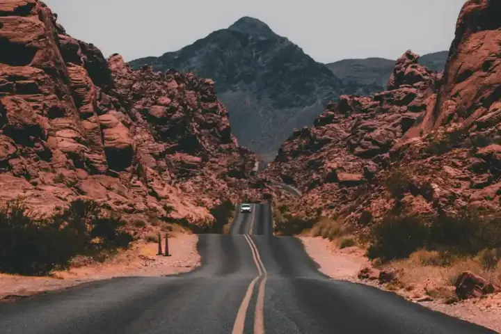 A multilane highway running through a forested mountain landscape.
