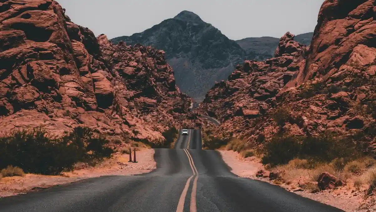 A multilane highway running through a forested mountain landscape.