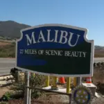 Coastal roadway and dry mountain brush along Pacific Coast Highway in Malibu, Southern California.