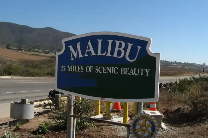 Coastal roadway and dry mountain brush along Pacific Coast Highway in Malibu, Southern California.