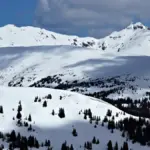 High-altitude snow-covered Rocky Mountain peaks and alpine terrain near Loveland Pass in Colorado.