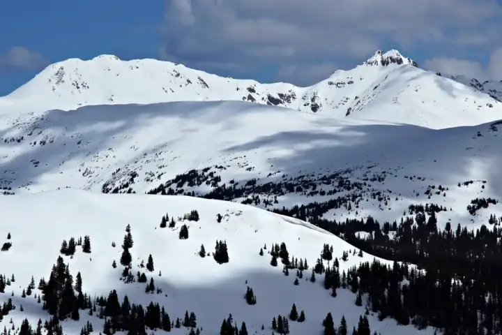 High-altitude snow-covered Rocky Mountain peaks and alpine terrain near Loveland Pass in Colorado.
