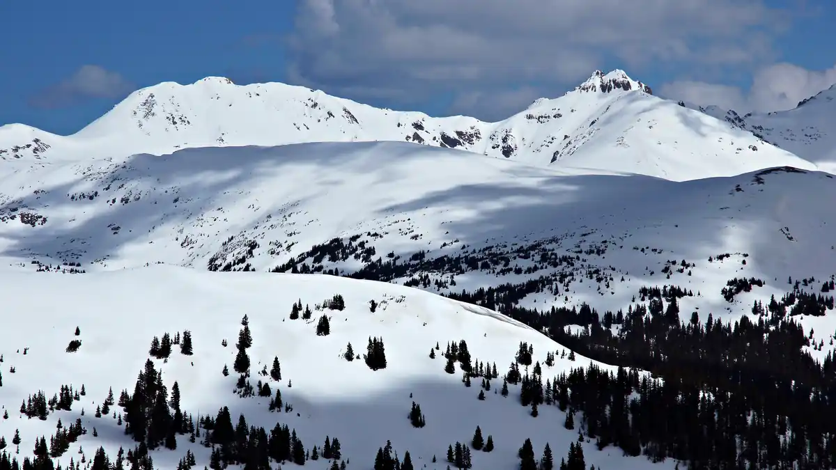 High-altitude snow-covered Rocky Mountain peaks and alpine terrain near Loveland Pass in Colorado.