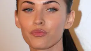 Close-up photographic portrait of actress Megan Fox facing forward at a red-carpet media appearance.