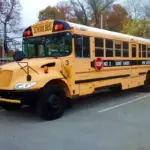 Yellow school bus at Saint Xavier High School, illustrating student transportation safety for intercity travel events.