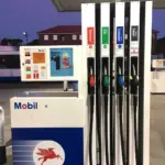 Green fuel nozzles and hoses at a petrol station