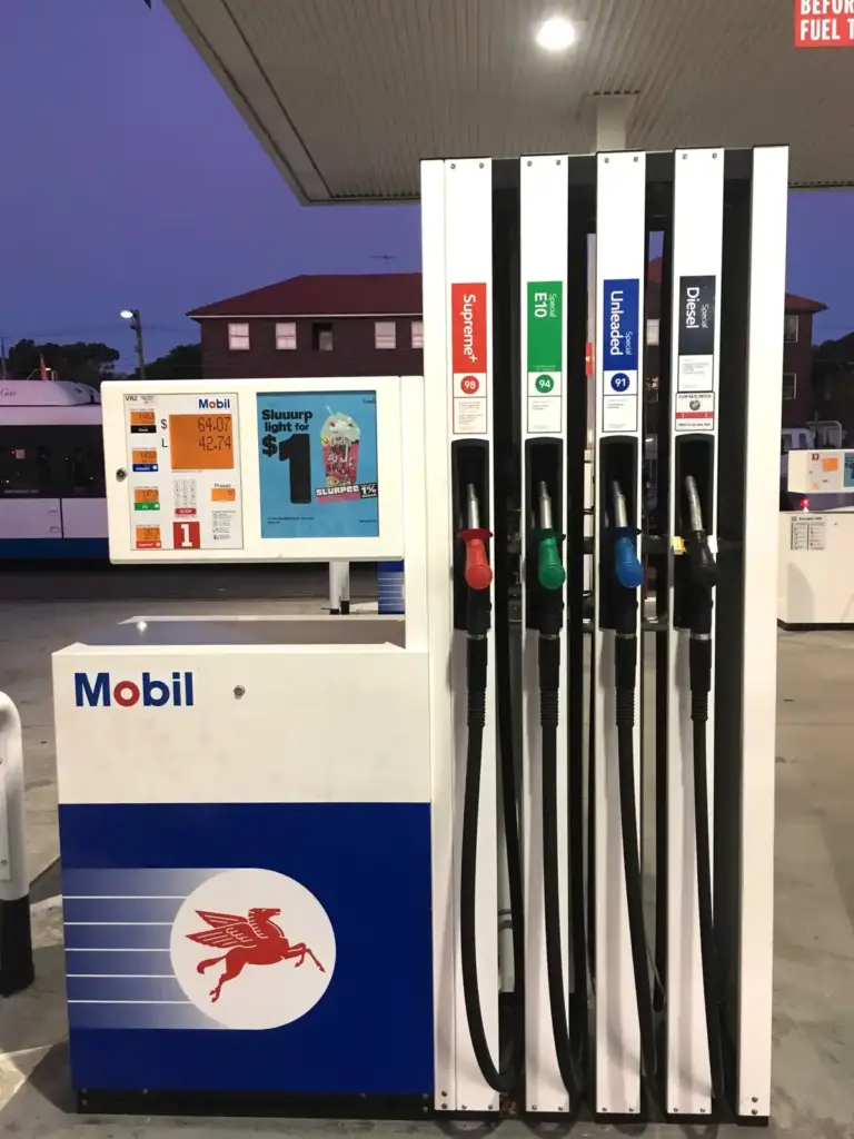 Green fuel nozzles and hoses at a petrol station