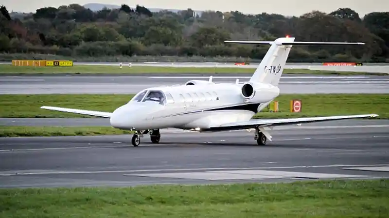 A private jet on an airport runway.