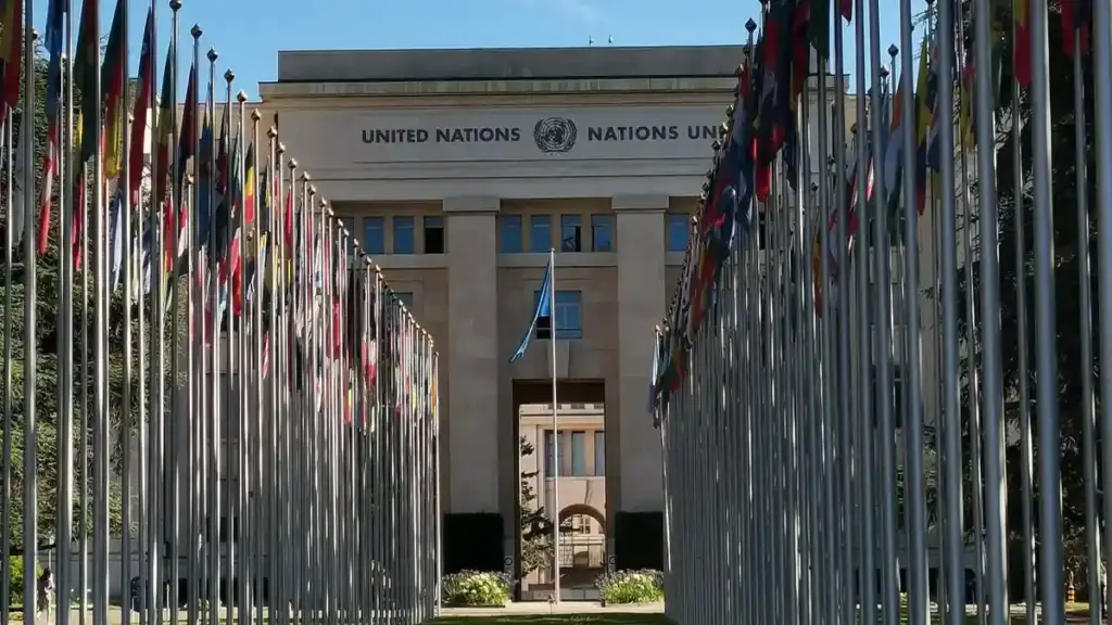 International flags line a government office plaza under clear skies.