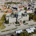 Aerial view of the National Assembly building in Belgrade surrounded by city streets.
