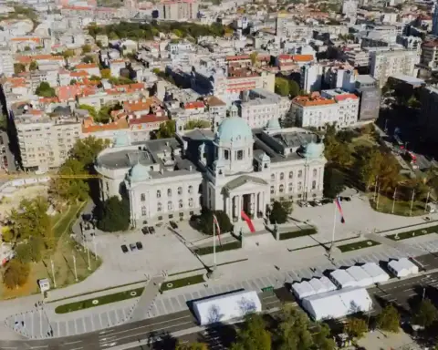 Aerial view of the National Assembly building in Belgrade surrounded by city streets.