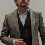 Portrait photograph of British television presenter Richard Hammond speaking into a microphone.
