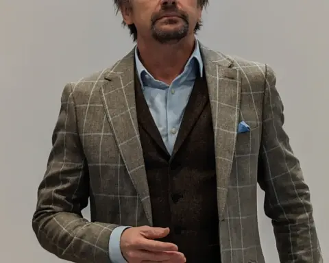 Portrait photograph of British television presenter Richard Hammond speaking into a microphone.