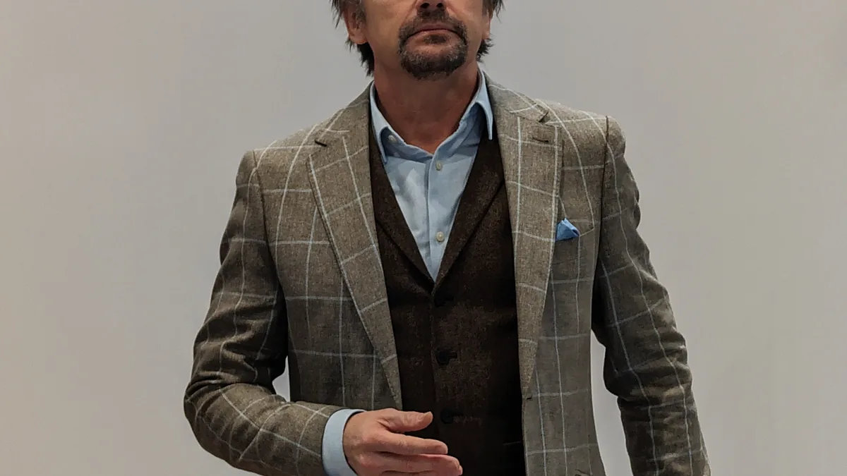Portrait photograph of British television presenter Richard Hammond speaking into a microphone.