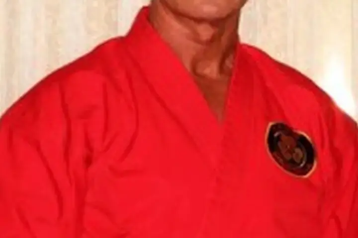 Australian actor and martial artist Richard Norton in a red martial-arts uniform