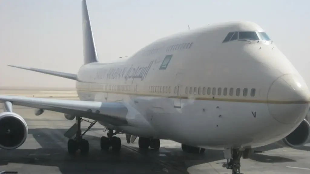 Commercial passenger airliner parked on the transit tarmac at King Khalid International Airport in Riyadh, Saudi Arabia.