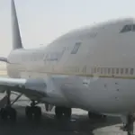 Commercial passenger airliner parked on the transit tarmac at King Khalid International Airport in Riyadh, Saudi Arabia.