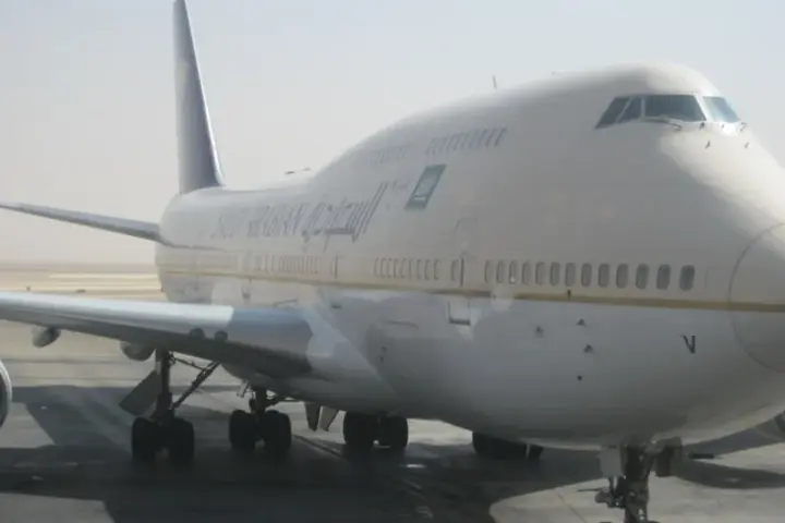 Commercial passenger airliner parked on the transit tarmac at King Khalid International Airport in Riyadh, Saudi Arabia.