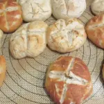 Fresh baked bread rolls on a tray, used as a representative image for a Great Value Hawaiian rolls recall report.