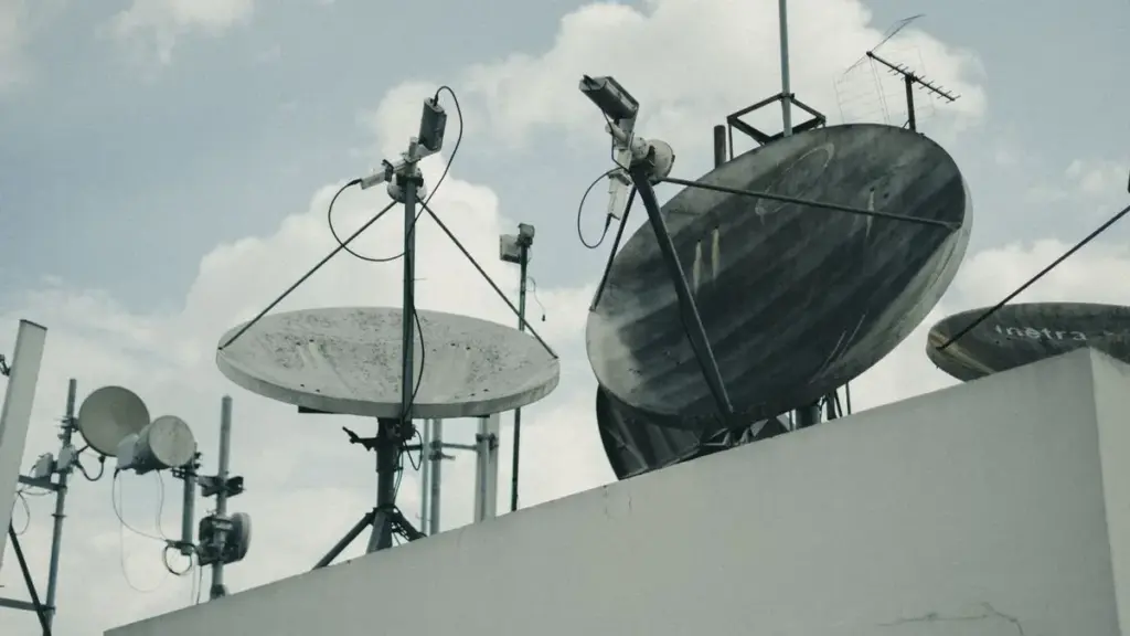 Satellite communication dishes and antennas on a building rooftop
