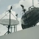 Satellite communication dishes and antennas on a building rooftop