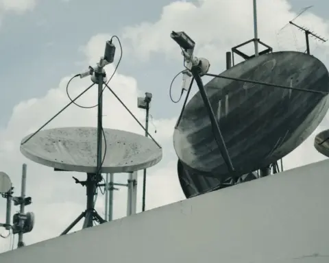 Satellite communication dishes and antennas on a building rooftop