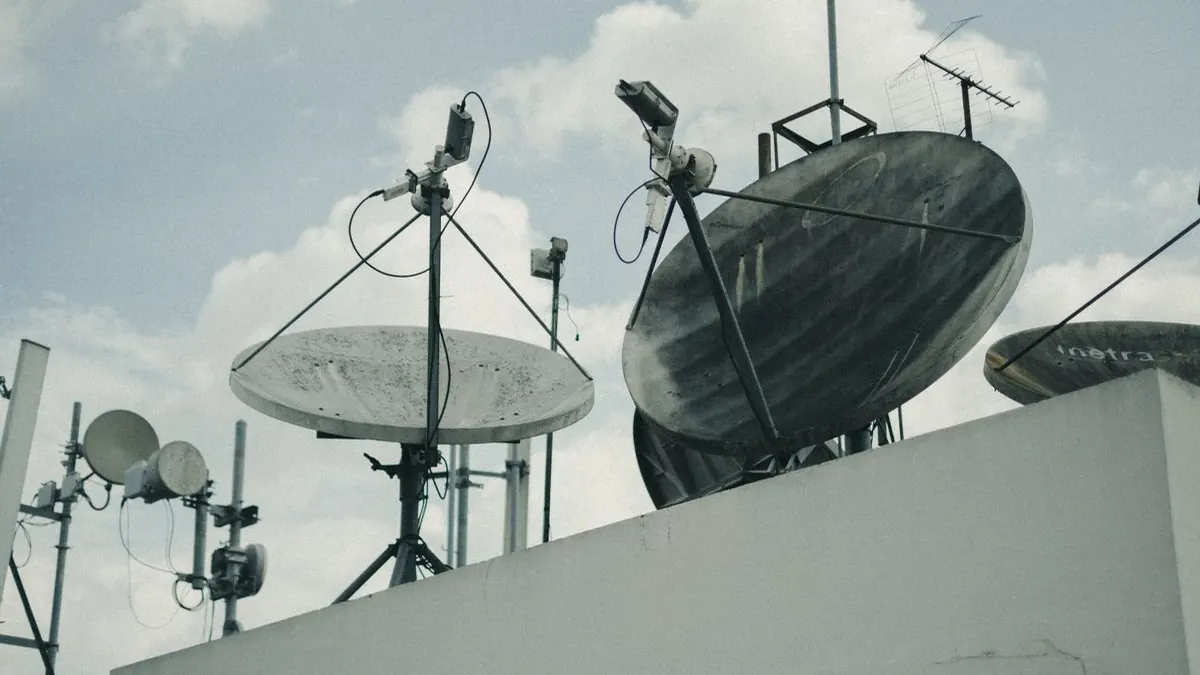 Satellite communication dishes and antennas on a building rooftop