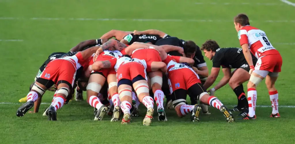 Rugby union forwards contesting a set-piece on a grass pitch.