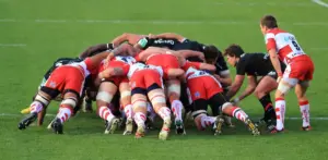 Rugby union forwards contesting a set-piece on a grass pitch.