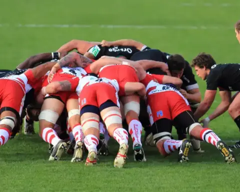 Rugby union forwards contesting a set-piece on a grass pitch.